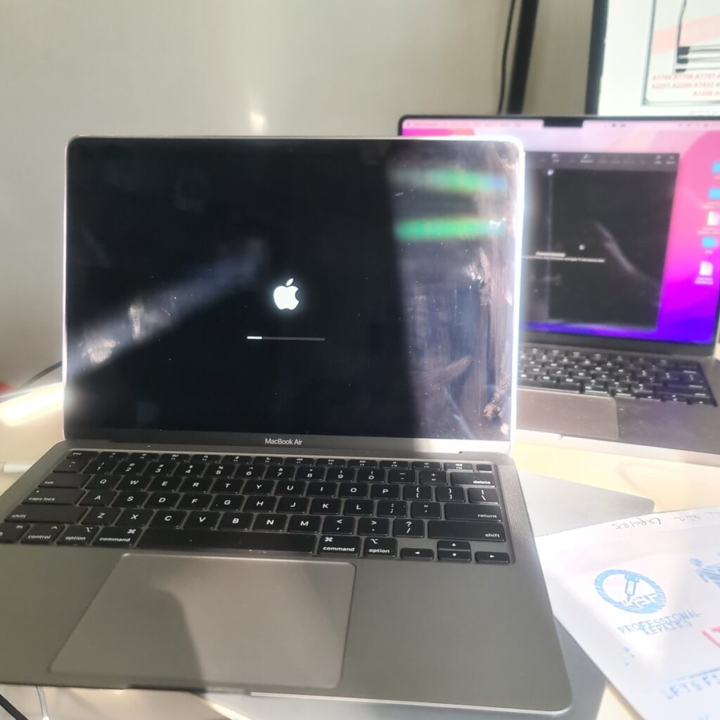 Screen of a Repaired MacBook Air 2020 showing the white Apple logo and loading progress bar after a successful firmware revive.