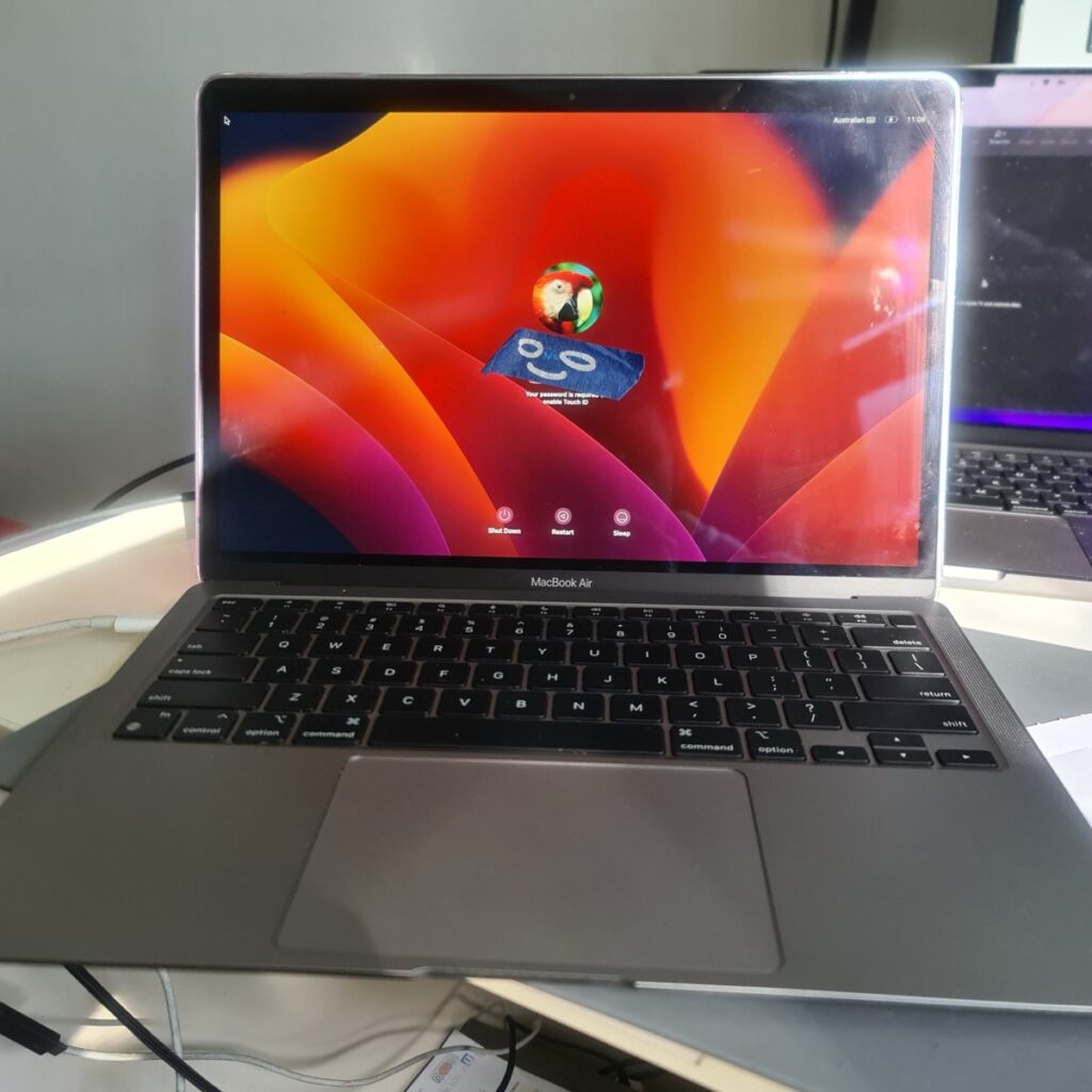 Fully functional 2020 MacBook Air M1 booted to the macOS user login screen, indicating successful repair and data recovery.