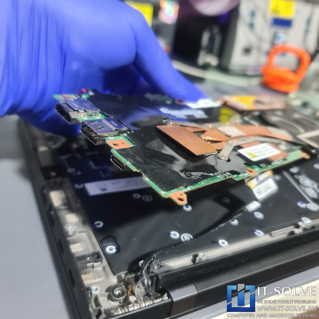 Photo of the logic board removed, showing the underside of the USB-C port area