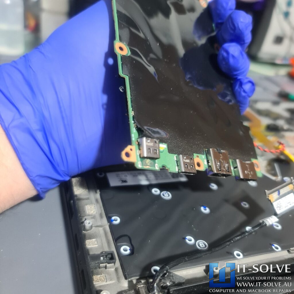 Photo of the logic board removed, showing the underside of the USB-C port area