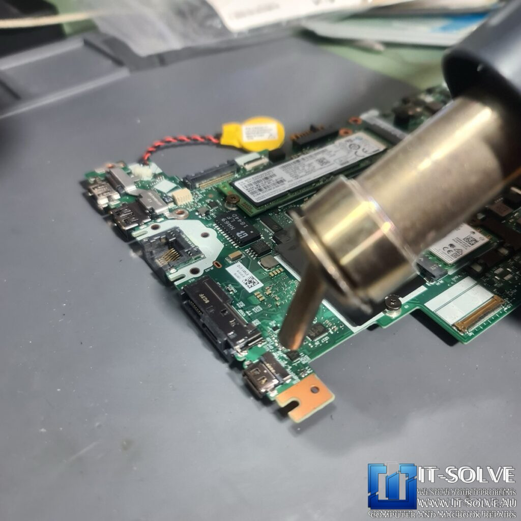 Photo of the logic board removed, showing the underside of the USB-C port area