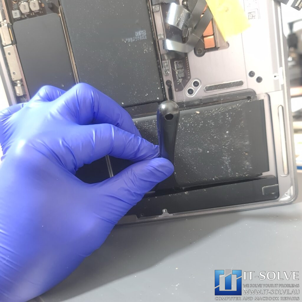 process of prying the battery out of the case of A2337 Macbook Air