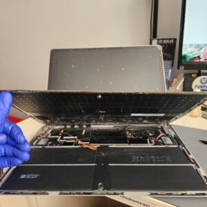 Photo showing the removed palmrest and heatsink with the motherboard exposed