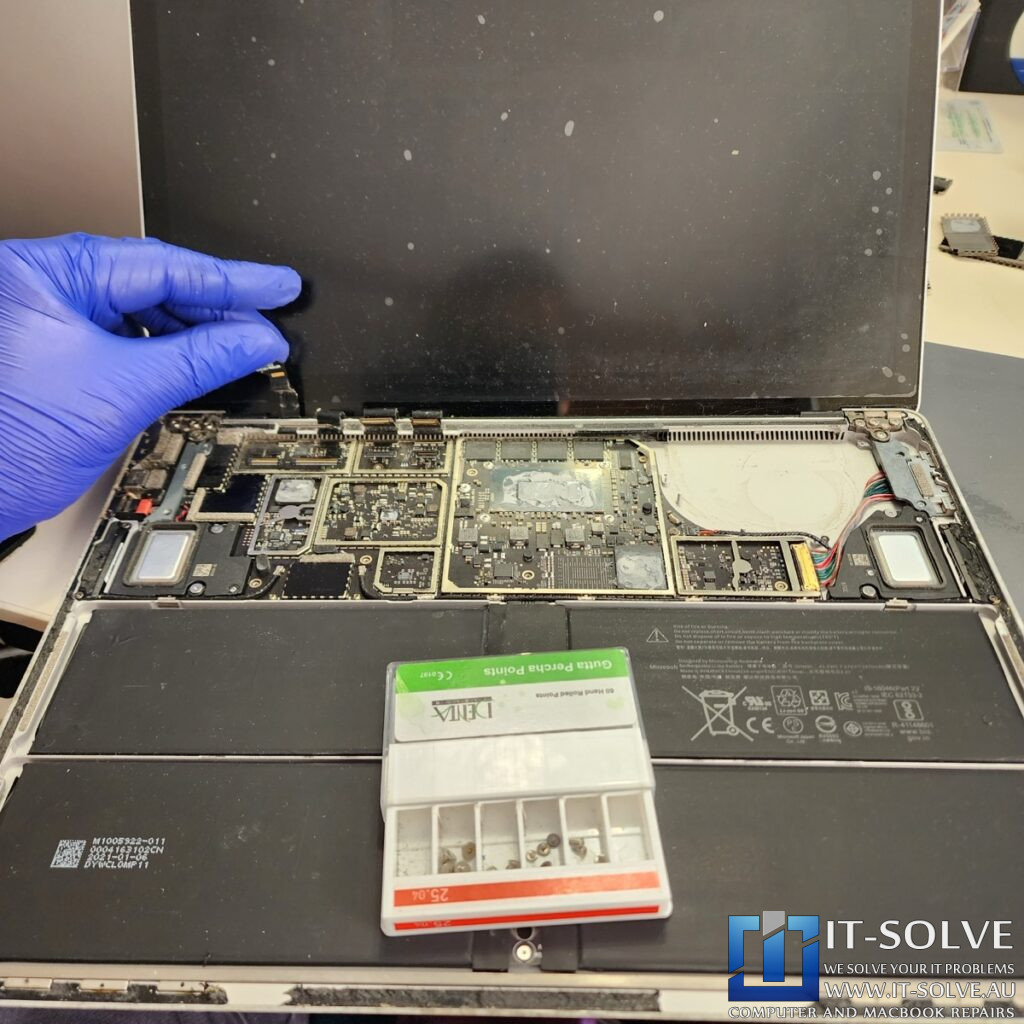 Photo showing the removed palmrest and heatsink with the motherboard exposed