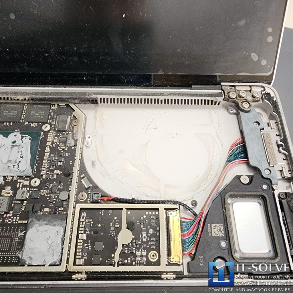 Photo showing the removed palmrest and heatsink with the motherboard exposed