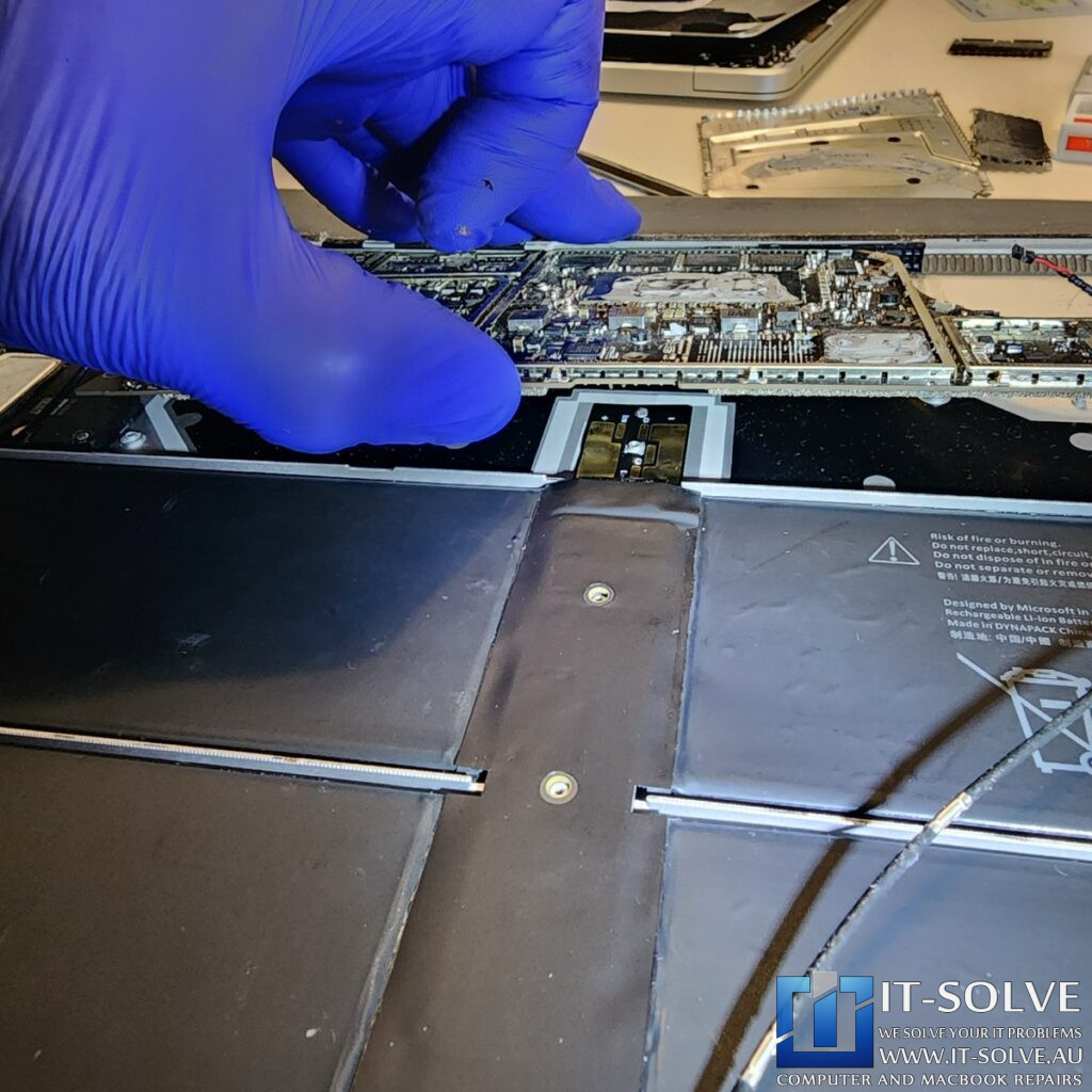 Photo of the genuine battery with matching model and part numbers