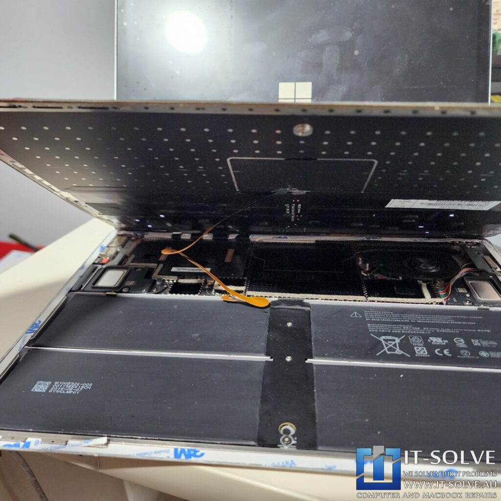 Photo showing the motherboard being reinstalled with fresh thermal paste